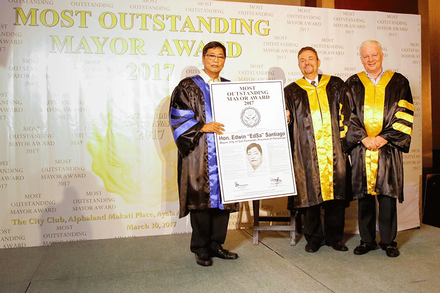 Mayor Edwin ‘EdSa’ Santiago presents his award as Most Outstanding Mayor in the Philippines given by Superbrand Marketing International Inc. President Harry Tambuatco and Chairman Karl Stuart Mclean on Thursday at The City Club, Alphaland Hotel in Makati.
